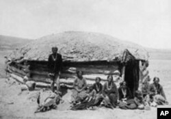 Traditional houses called hogans, are made of logs and covered with earth or adobe, to help keep out both the raging heat and bitter cold of the Navajos' high-desert homeland.