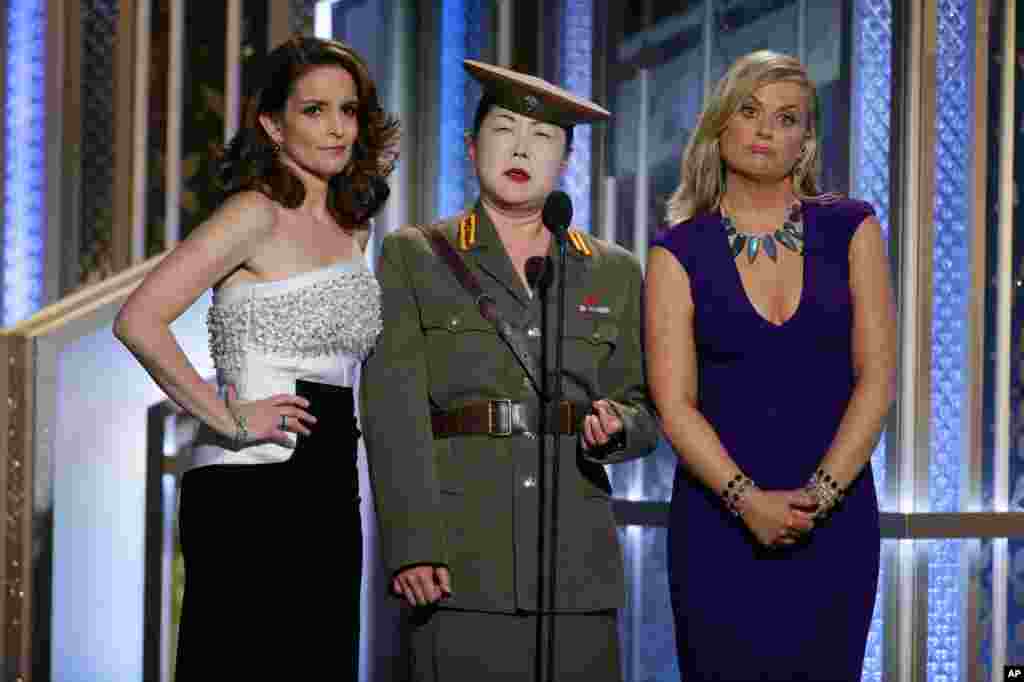 In this image released by NBC, Tiny Fey (from left), Margaret Cho and Amy Poehler speak at the 72nd Annual Golden Globe Awards at the Beverly Hilton Hotel in Beverly Hills, California, Jan. 11, 2015.