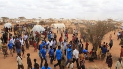 UN High Commissioner for Refugees Antonio Guterres, center right, in white shirt, walks with UNHCR staff and Somali refugees during a visit to Dagahaley Camp, near Dadaab, Kenya.