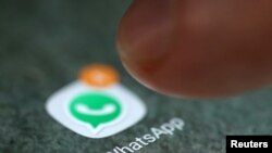 FILE - The WhatsApp icon is seen on a smartphone.