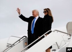 President-elect Donald Trump, accompanied by his wife Melania, waves as they arrive at Andrews Air Force Base, Maryland, Jan. 19, 2017.