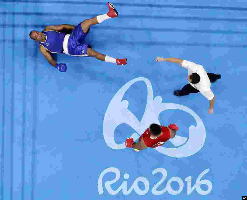 Cape Verde's Davilson Dos Santos Morais, is knocked down by Britain's Joe Joyce during a men's super heavyweight over 91-kg preliminary boxing match at the 2016 Summer Olympics in Rio de Janeiro, Brazil, Aug. 13, 2016.