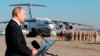 FILE - In this Dec. 12, 2017 file photo, Russian President Vladimir Putin addresses the troops at the Hemeimeem air base in Syria.