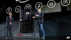 LG Electronics’ vice president David VanderWaal and Amazon Echo vice president Mike George present the LG Smart InstaView Door-in-Door Refrigerator to CES 2017 attendees at the LG Electronics press conference, Jan. 4, 2017, in Las Vegas.