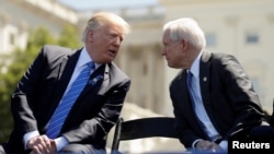 FILE - President Donald Trump speaks with Attorney General Jeff Sessions as they attend the National Peace Officers Memorial Service on the West Lawn of the U.S. Capitol in Washington, May 15, 2017.