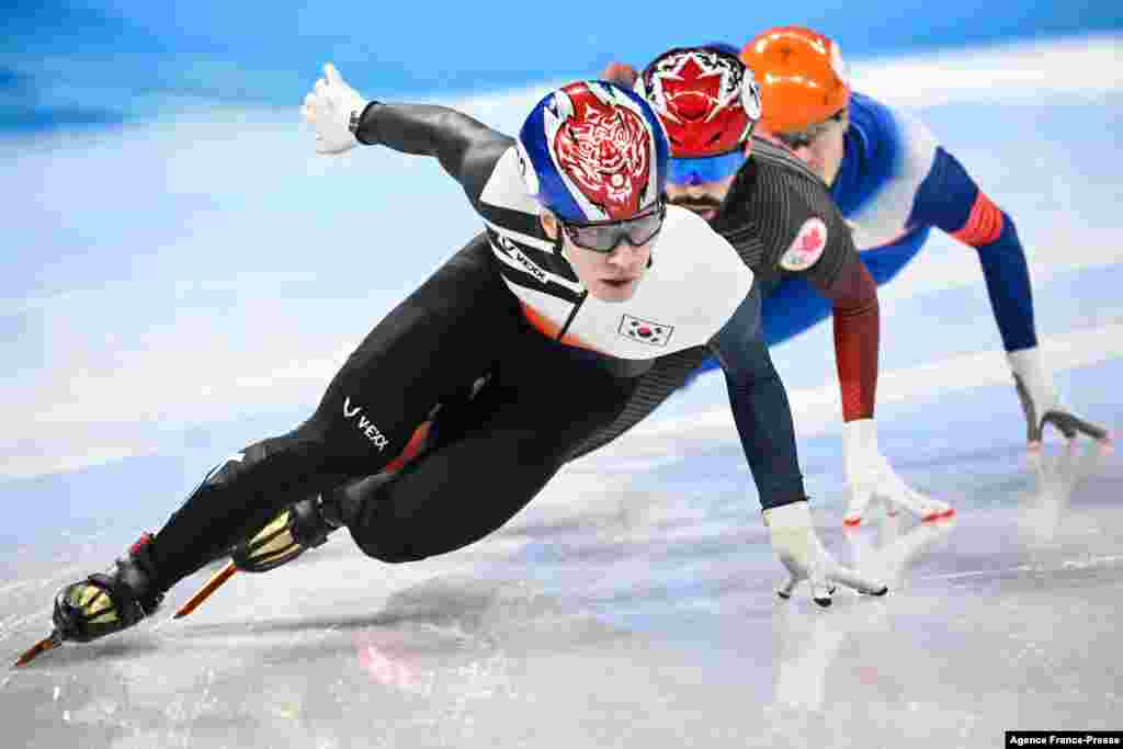 South Korea&#39;s Hwang Dae-heon, Canada&#39;s Steven Dubois and Russia&#39;s Semen Elistratov compete in the final A of the men&#39;s 1500m short track speed skating event during the Beijing 2022 Winter Olympic Games at the Capital Indoor Stadium in Beijing.