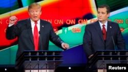 Republican U.S. presidential candidate businessman Donald Trump (L) speaks as Senator Ted Cruz (R) looks on during the Republican presidential debate in Las Vegas, Nevada, Dec. 15, 2015. 