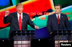 FILE - Republican U.S. presidential candidate businessman Donald Trump (L) speaks as Senator Ted Cruz (R) looks on during the Republican presidential debate in Las Vegas, Nevada, Dec. 15, 2015.
