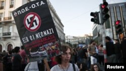 A protester holds a banner during an anti-fascist rally in Athens, Sept. 25, 2013. 