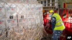  In this photo provided by the Australian Defense Force, pre-flight checks are made on humanitarian assistance and supplies onboard an aircraft at RAAF Base Amberley, Australia, Jan. 21, 2022, bound for Tonga after a volcanic eruption. 