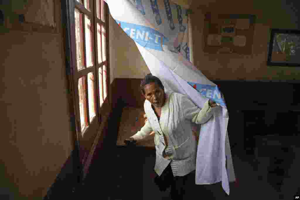 A woman walks off after she voted at a polling station in Antananarivo, Madagascar, Oct. 25, 2013.