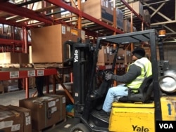 Ex-offender Wade Tate drives a forklift for DSI Warehouse in greater Memphis, Tenn. His boss says customers ask to meet Tate in person to offer thanks for his computer assistance with their orders. (C. Presutti / VOA)