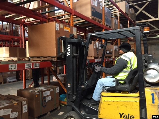 Ex-offender Wade Tate drives a forklift for DSI Warehouse in greater Memphis, Tenn. His boss says customers ask to meet Tate in person to offer thanks for his computer assistance with their orders. (C. Presutti / VOA)