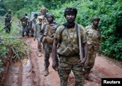 FILE - Seleka fighters search for anti-balaka Christian militia members near town of Lioto, Central African Republic, in June 2014.