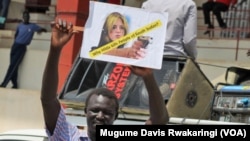 A protester at a rally in Juba on March 10, 2014, holds up a sign against UNMISS head Hilde Johnson.