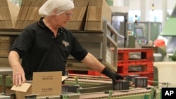 An employee packs boxes of tea at the production line at Taylors of Harrogate's tea packaging facilities in Harrogate, England, Aug. 30, 2016. 