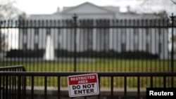 A restricted area sign is seen outside of the White House in Washington on Nov. 27, 2015. A man who jumped the White House fence on Thursday was quickly caught and now faces criminal charges. 