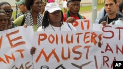 Environmental activists demonstrate outside the United Nations Framework Convention on Climate Change Conference of the Parties meeting in Durban, November 29, 2011.