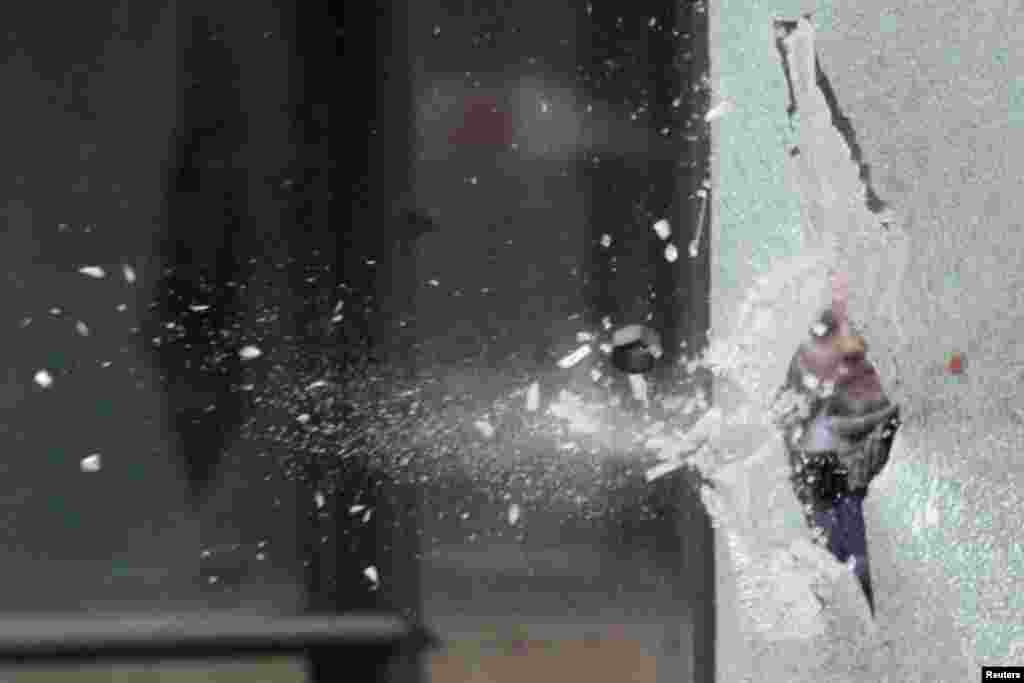 A bolt thrown by an Arcelor Mittal employee breaks the glass at a bus stop during a protest in Strasbourg, France. Arcelor Mittal, the world&#39;s largest steel producer, plans to shut a coke plant and six finishing lines at its site in Liege, Belgium, affecting 1,300 employees.