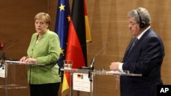 Algerian Prime Minister Ahmed Ouyahia (R) and German Chancellor Angela Merkel answer questions during a joint press conference held in Algiers, Algeria, Sept.17, 2018. 