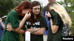 Mourners gather at a makeshift memorial left in memory of the victims killed in a shooting at Santa Fe High School in Santa Fe, Texas, U.S., May 21, 2018. 