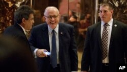 Rudy Giuliani, center, leaves Trump Tower in New York, Nov. 11, 2016. The former New York mayor is expected to be considered for the position of attorney general for President Donald Trump.