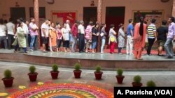Voters line up at polling booths in the capital New Delhi where voting was held Sunday in the second last round of India's staggered general election. 