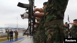 FILE - Troops stand at attention at the KFOR (NATO'S Kosovo force) headquarters in Pristina, Jan. 23, 2015.