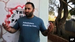 Palestinian activist Issa Amro, center, speaks after his release from detention, in the West Bank city of Hebron, Sept. 10, 2017.