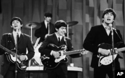 The Beatles perform on the CBS "Ed Sullivan Show" in New York on Feb. 9, 1964.