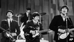 The Beatles perform on the CBS "Ed Sullivan Show" in New York on Feb. 9, 1964.