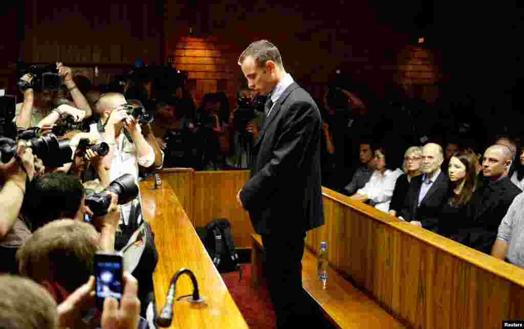 Oscar Pistorius stands at the dock before the start of proceedings, February 22, 2013.