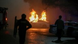 FILE - A police car burns during a protest following the Kazakh authorities' decision to lift price caps on liquefied petroleum gas in Almaty, Kazakhstan, Jan. 5, 2022.