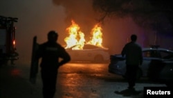 A police car burns during a protest following the Kazakh authorities' decision to lift price caps on liquefied petroleum gas in Almaty, Kazakhstan, Jan. 5, 2022. 