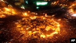 FILE - Egyptians celebrate after President Hosni Mubarak resigned and handed power to the military at Tahrir Square, Feb. 11, 2011.