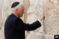U.S. Vice President Mike Pence touches the Western Wall, Judaism's holiest prayer site, in Jerusalem's Old City, Jan. 23, 2018.