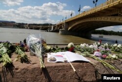 Flowers are placed next to the Margaret bridge in respect for the victims of a boating accident on the Danube river, in Budapest, Hungary, June 1, 2019.