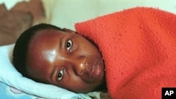 25-year-old South African, Lawrence Jet who is HIV-positive lies on his bed (file photo)