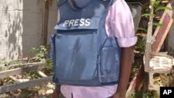 FILE - In this photo taken March 22, 2014, a Somali journalist is seen in Mogadishu, Somalia.