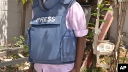 FILE - In this photo taken March 22, 2014, a Somali journalist is seen in Mogadishu, Somalia.
