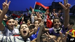 Libyan children celebrate in Souk el-Juma district in Tripoli, Libya, Oct. 21, 2011.