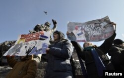 FILE - Supporters of Russian opposition leader Alexei Navalny attend a rally for a boycott of a March 18 presidential election in the far eastern city of Vladivostok, Russia, Jan. 28, 2018.