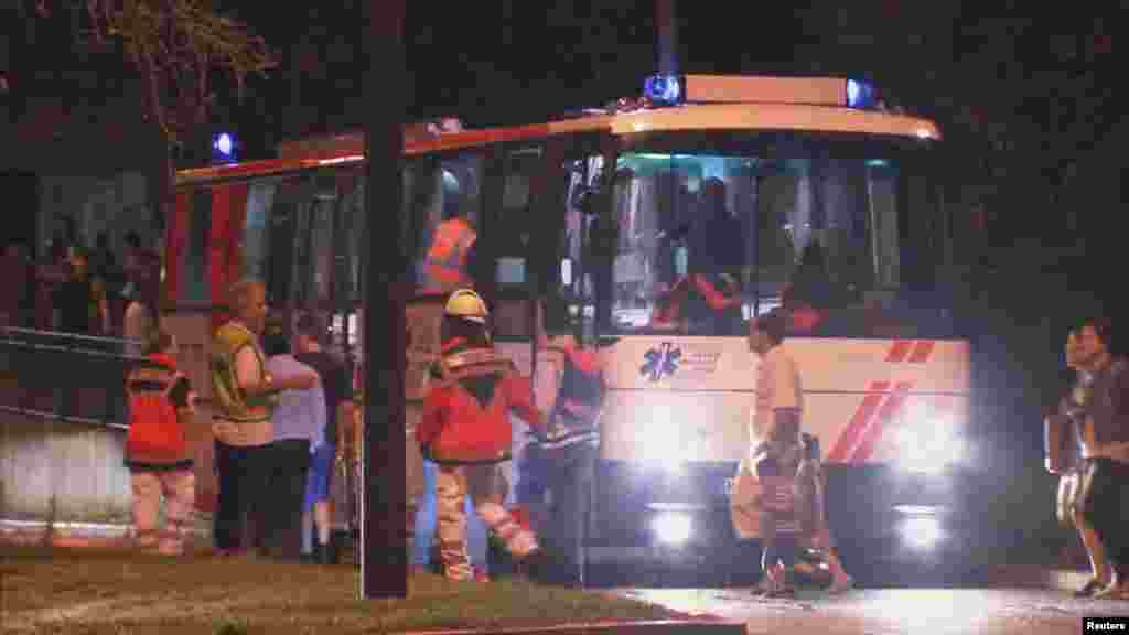 A screen grab taken from video footage shows people being evacuated onto a bus following a shooting rampage at the Olympia shopping mall in Munich, Germany July 22, 2016. 