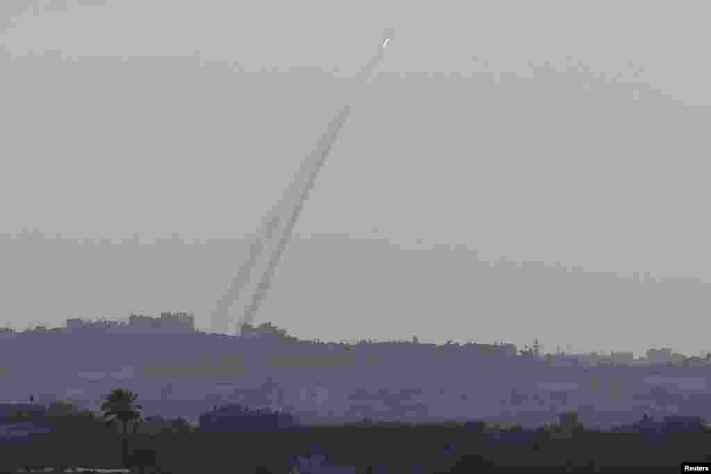 Smoke trails are seen as a rocket is launched from the northern Gaza Strip towards Israel, July 15, 2014.