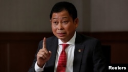 FILE - Indonesian Minister of Energy and Mineral Resources Ignasius Jonan gestures during an interview at his office in Jakarta, Aug. 22, 2017. 