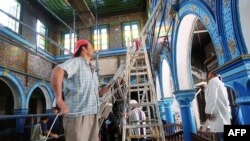 Workers repair damage in the historic Ghriba synagogue in Djerba, April 21, 2002, after an explosion April 11, 2002, causes by a suspected extremist attack that killed 21 people.