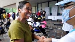 FILE - Boston mayoral candidate Andrea Campbell greets people before the start of the Roxbury Unity Parade, in Boston's Roxbury neighborhood, July 18, 2021.