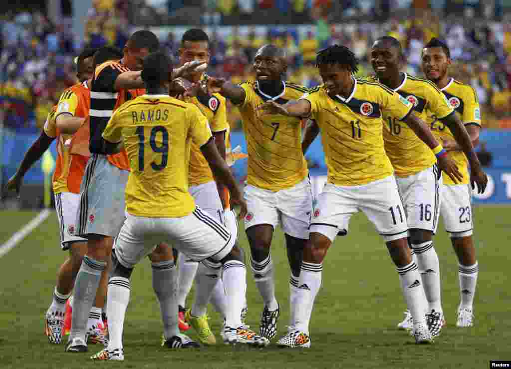 Colombia's team celebrates Juan Cuadrado's goal against Japan at the Pantanal arena in Cuiaba, June 24, 2014.