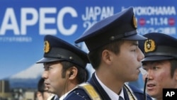Police officers guard at a checkpoint to the enclosure of the APEC forum venue in Yokohama, near Tokyo as ministerial level meetings started in the day ahead of the Nov. 13-14 leaders' summit, 10 Nov 2010.