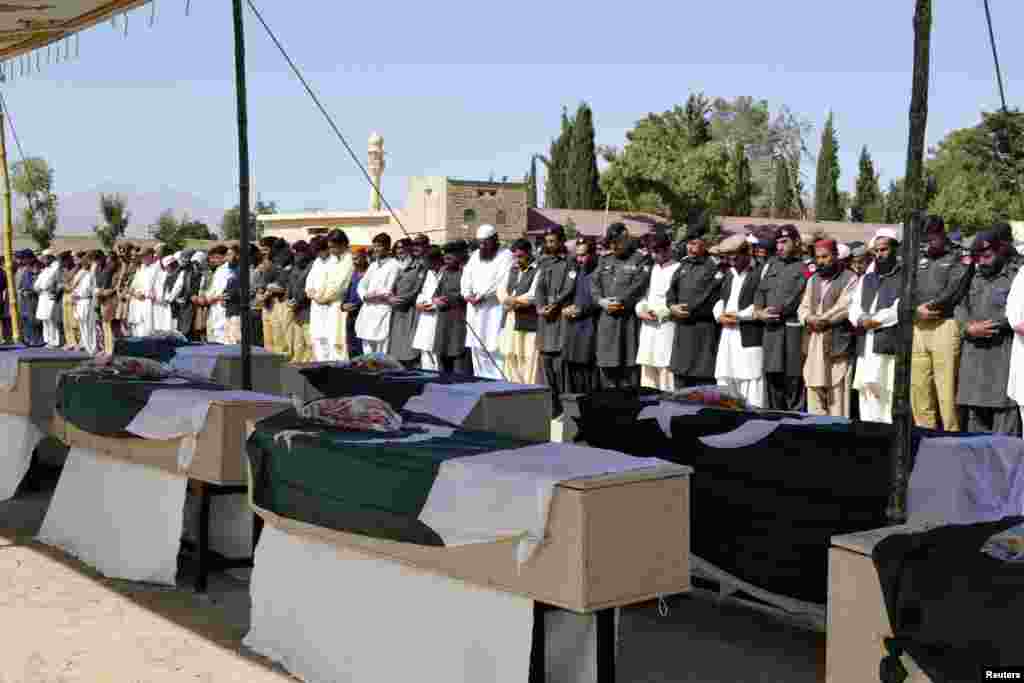 Mourners pray as they attend the funeral of victims killed in a bomb blast, Quetta, Pakistan, May 23, 2013.